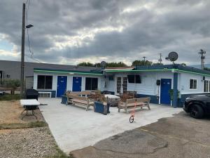 a blue house with benches in front of it at Budget Inn And Suites Eagan in Eagan