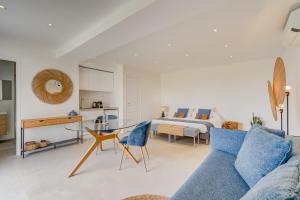 a living room with a blue couch and a bed at Ideal BnB, Luxury Apartments in Saint Paul de Vence +130 photos