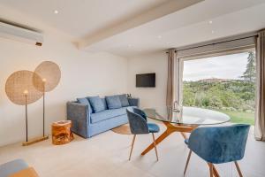 a living room with a blue couch and a glass table at Ideal BnB, Luxury Apartments in Saint Paul de Vence