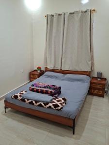a bedroom with a bed with a cow blanket on it at Appartements Playa NDB City in Nouadhibou