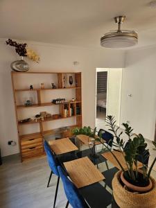 a dining room with a table and blue chairs at Casa en La Marina cerca de la Playa y Pinada in Elche