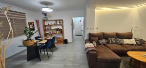 a living room with a couch and a table at Casa en La Marina cerca de la Playa y Pinada in Elche
