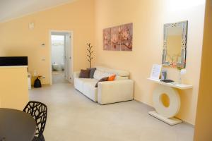 a living room with a couch and a table at Casa Sole - holiday apartment in Maccagno Superiore