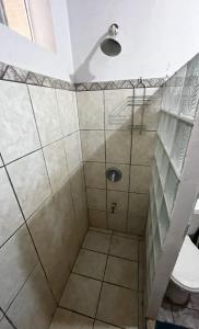 a bathroom with a shower with a toilet at Avellanas Surf Hostel in Playa Avellana