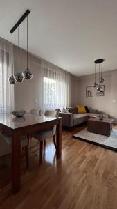 a living room with a table and a couch at SiM Lux in Čačak