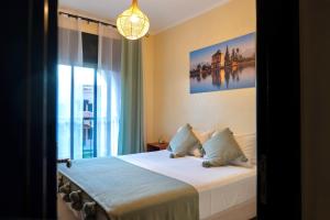 a bedroom with a bed and a large window at Palm View in Marrakesh