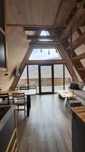 a living room with a large window in a cabin at Ditaket Dilijan in Dilijan