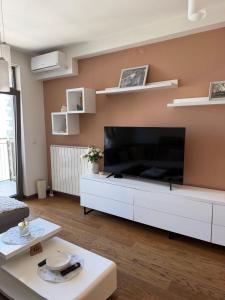 a living room with a large flat screen tv at Belgrade Waterfront Wolf in Sajmište