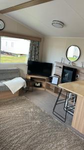 a living room with a couch and a table at Crichtons Caravan at Haven Seton Sands in Port Seton