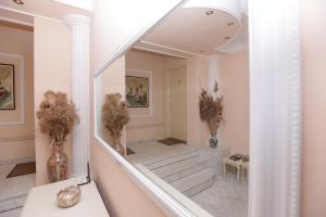 a hallway with a mirror and stairs in a house at Vila Oaza in Bela Crkva +14 photos
