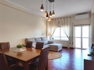 a living room with a couch and a table at Apartment by the beach! With large balcony! in São Martinho do Porto