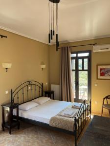 ein Schlafzimmer mit einem Bett und einem Fenster in der Unterkunft August Andros in Ándros + 14 Fotos
