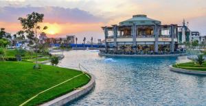 a large building in the middle of a river at Luxury Smart Home Entire Apartment with 2 Bedrooms in Madinaty in Madinaty