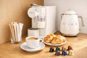 a table with a cup of coffee and croissants at Princess Palace Monaco in Monte Carlo