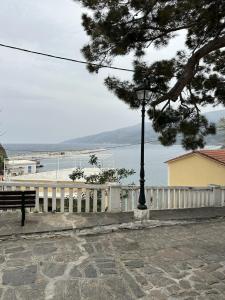 a bench and a street light in front of the water at Evdilos Icaria 'Sto Plakostroto' by BRP-Properties in Evdilos