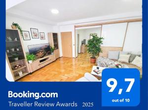 a living room with a couch and a tv at Seven Tower FREE PARKING in Skopje