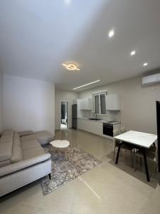 a living room with a couch and a table at Aron apartments in Tirana