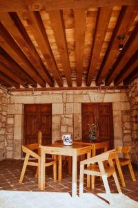 a wooden table and chairs in a room at Navarrete 63 Hotel in Morelia