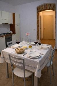 a table with glasses of wine and food on it at Cilento House with Garden & Sunset View in Sessa Cilento