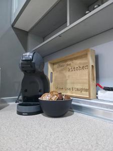 a food processor and a bowl of food on a counter at Exclusive Apartment Main Square FREE PARKING in Skopje
