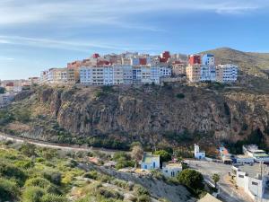 a group of buildings on top of a mountain at Résidence Bario H in Al Hoceïma