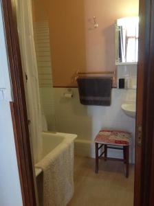 ein Badezimmer mit einer Badewanne und einem Waschbecken in der Unterkunft Maison Lacoste in Campan
