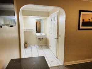 a bathroom with a sink and a mirror at Imperial Inn & Suites in Norwalk