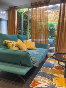 a living room with a couch and a window at The Beach Dream in Saint-Laurent-du-Var