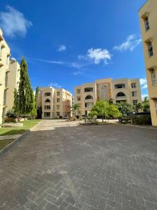 an empty parking lot in front of some buildings at Pristine Home - Cozy Luxury Residence in Mtwapa