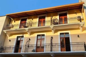 a building with red doors and balconies at San Felipe Loft in Panama City