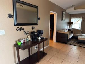 a living room with a table and a mirror on the wall at Acreage Oasis - 5 Bedrooms, Pool, Space, Serenity in West Palm Beach