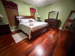 a bedroom with a bed with a teddy bear on it at Acreage Oasis - 5 Bedrooms, Pool, Space, Serenity in West Palm Beach +61 photos