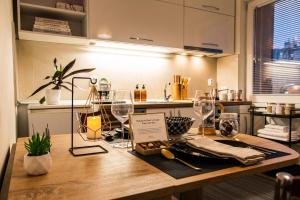 a kitchen with a wooden table with wine glasses on it at Prime Main Square Location in Skopje