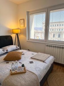 a bedroom with a bed with two bottles on it at Prime Main Square Location in Skopje