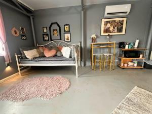 a living room with a bed and a rug at The Studio at Stardust Retreat in Coleman