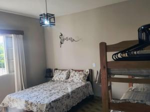 a bedroom with a bed and a bunk bed at Espaço Meditare in Socorro