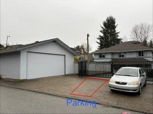 a white car parked in a driveway in front of a house at 3Beds Ground-Level Private Suite in Burnaby in Burnaby