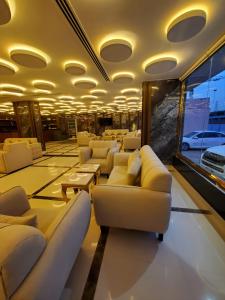 a living room with couches and tables and a window at سهول بارك in Riyadh