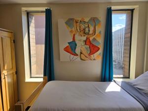 a bedroom with a bed and a painting on the wall at Stay Pittsburgh in Pittsburgh