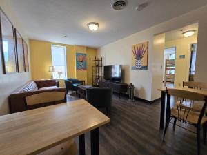a living room with a couch and a tv at Stay Pittsburgh in Pittsburgh