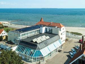 a building on the beach next to the ocean at 4 person holiday home in Hejls-By Traum in Hejls