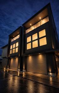 a building with lit windows on the side of it at Charm Roger Luxury Room 2 in Kamakura