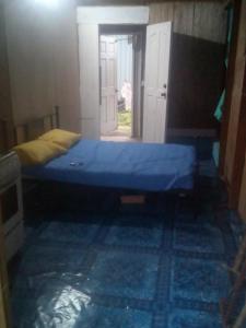 a bedroom with a blue bed in a room at Mabouya Villas in Dennery