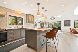 a kitchen with a large island with bar stools at The Kingfisher Lodge in Cornell