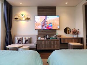 a hotel room with two beds and a flat screen tv at Yana Apec Phu Yen in Tuy Hoa +36 photos