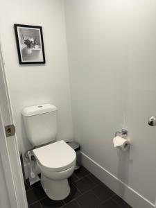 a bathroom with a toilet and a picture on the wall at The Shed Bed & Breakfast in Hay +9 photos