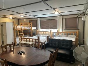 a room with two bunk beds and a table at Cougar Mountain Lodge and Resort Cabin Rentals in Valemount