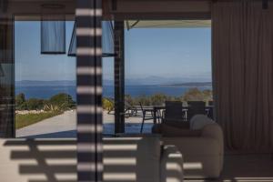 a living room with a couch and a view of the ocean at Kai House in Lun