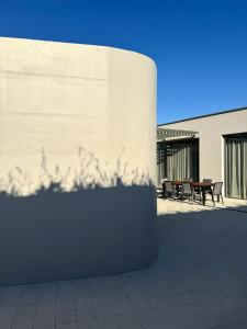 a wall with a table and benches next to a building at Kai House in Lun +52 photos