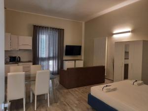 a hotel room with two beds and a table and chairs at TRANI LA GRAZIA b&b in Trani
